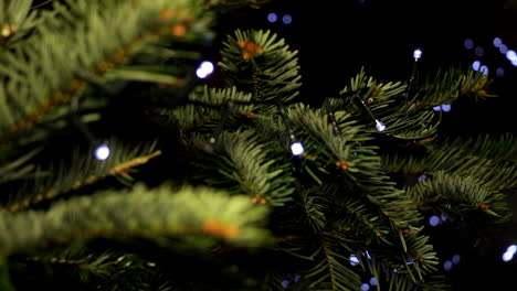 Close-Up-and-Focus-Pull,-Christmas-Tree-with-LED-String-Lights-and-Bokeh