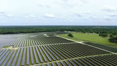 Solar-Farm-Drone-Footage,-Pan-and-Pull-Back-over-Solar-Farm
