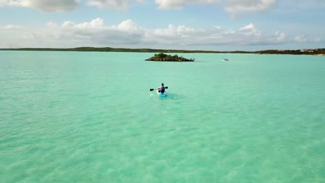 Kayaker-paddling-on-the-ocean-off-the-coast-of-Providenciales-in-the-Turks-and-Caicos-archipelago-1