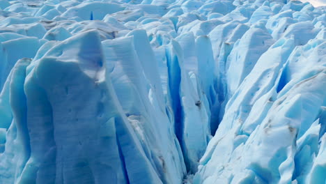 Large-Crevasses-melting-in-sunlit-blue-glacier,-close-up