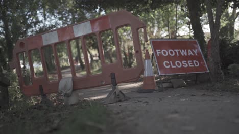 4K-timelapse-on-motion-slider-showing-a-toe-path-that-has-been-closed-off,-with-people-ignoring-the-signs