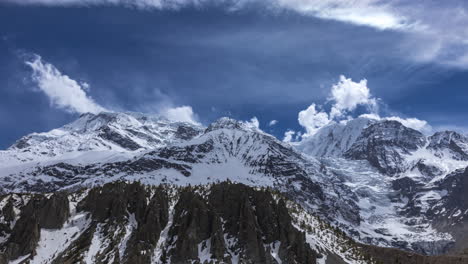 Day-timelapse-overlooking-the-Annapurna-Mountain-Range-with-clouds-on-a-sunny-day-from-Manang,-Nepal