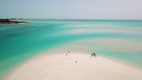 People-on-a-white-sandy-beach-in-Providenciales-in-the-Turks-and-Caicos-archipelago