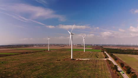 Aerial-shot-of-working-wind-generatiors-in-wide-green-field---Kaliakra,-Bulgaria