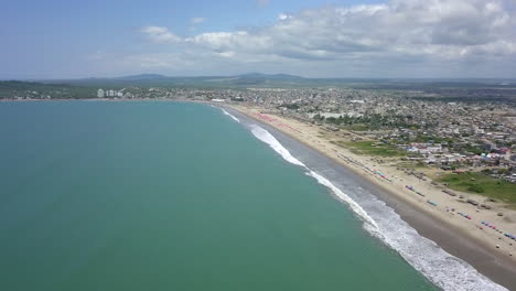 Drone-shot-flying-over-the-beach-in-the-town-of-Playas-General-Villamil,-Ecuador-2