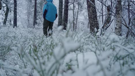 Guy-walkes-in-snowy-forest