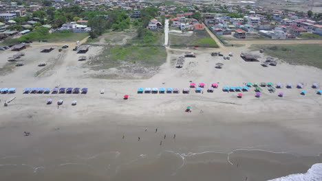 Revealing-drone-shot-from-near-the-coast-over-the-ocean-towards-the-town-of-Playas-General-Villamil-in-Ecuador