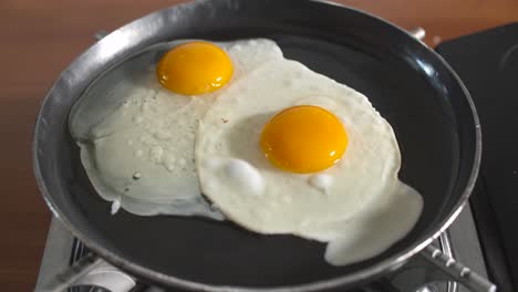 Chef-cracking-egg-in-hot-pan-for-cooking