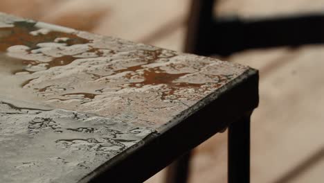 Rain-falling-on-corner-of-stone-table-in-Oregon-June