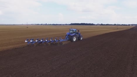 Blue-Modern-Plowing-Tractor-Working-In-The-Field-3