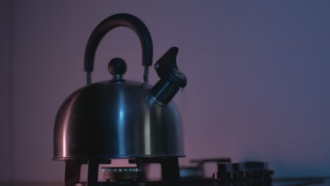 The-Reflection-Of-Light-Moves-On-A-Metal-Kettle-Heated-On-A-Gas-Stove-In-The-Kitchen