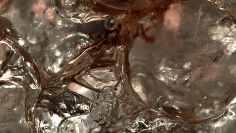 Pouring-Cola-on-ice-cubes-extreme-close-up-1