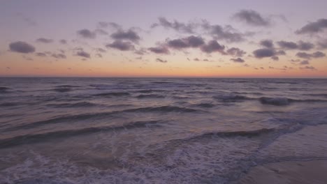 Sea-Waves-Rinse-Seaside-Beach-At-Sunset