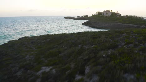 Schöne-Küste-Mit-Wellen,-Die-Felsen-Bei-Sonnenuntergang-Auf-Der-Turks--Und-Caicosinsel-Spritzen