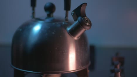 The-Boiling-Metal-Kettle-is-removed-from-the-Gas-Stove