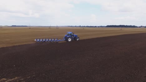 Blue-Modern-Plowing-Tractor-Working-In-The-Field-4