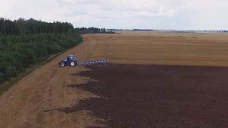 Blue-Modern-Plowing-Tractor-Working-In-The-Field-6
