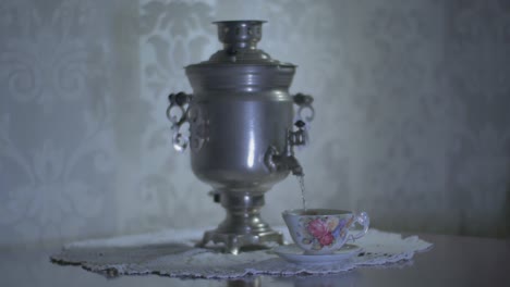 Gießen-Sie-Heißes-Wasser-Aus-Einem-Sowjetischen-Vintage-Samowar-Elektro-Metall-Teekessel-In-Eine-Wunderschöne-Tasse-2