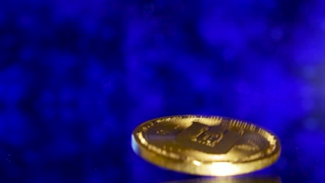 Close-Up-Of-Dropping-Golden-Dash-Coin-On-A-Mirroring-Ground-With-Futuristc-Moving-Blue-Background