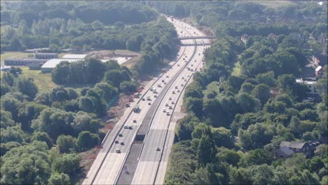 Busy-M37-aerial-drone-shot-following-vehicles,-cars-along-the-road