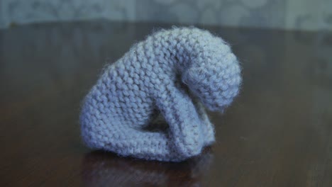 Handmade-Small-Yarn-Crochet-Lamb-Sitting-On-A-Wooden-Table