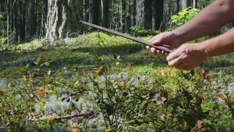 A-Man-Finds-Rifle-Weapon-Dagger-Blade-In-The-Forest-Moss-1