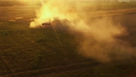 Tractor-Works-in-Dusty-Agricultural-Fields-on-a-Sunny-Summer-Evening