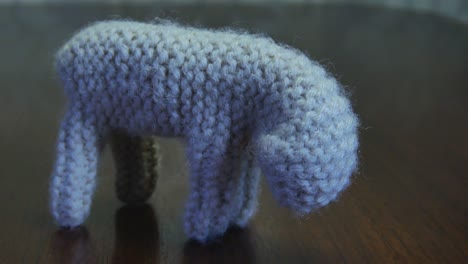 Handmade-Small-Yarn-Crochet-Lamb-Standing-On-A-Wooden-Table