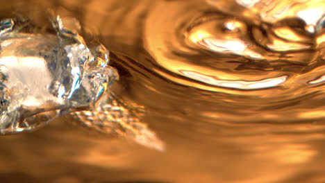 Ice-breaks-through-the-surface-of-a-cold-drink-in-dramatic-slow-motion