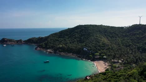Drone-aerial-shot-of-beach-bay-and-island-with-turquoise-water-in-Koh-Tao,-Thailand