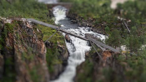 A-aerial-view-of-the-newly-built-bridge-above-the-magnificent-Voringsfossen-waterfall-in-Hardangervidda-national-park,-Norway