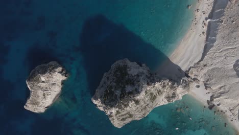 Mizithres-rocks-in-the-Zakynthos,-beautiful-top-down-drone-shot-with-the-rock-formations-in-the-middle-casting-shadows-on-the-sea