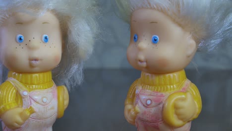 Close-Up-Of-Two-Toy-Twin-Dolls-with-White-Hair-and-Blue-Eyes