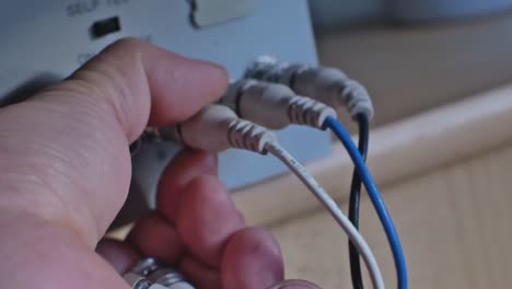 Close-Up-Of-Disconnecting-Wires-With-Old-Type-Connectors-From-CRT-Monitor