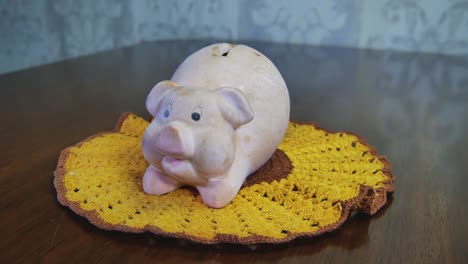 Old-Dirty-Pig-Piggy-Money-Saver-Bank-On-Crocheted-Yellow-Napkin