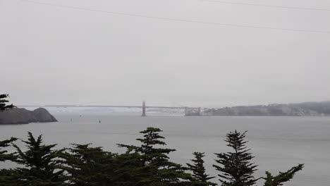 Long-Shot-of-the-Golden-Gate-Bridge-and-San-Francisco-Bay-on-a-cloudy,-hazy,-foggy,-muggy,-summer-afternoon-on-the-Point-Bonita-Trail