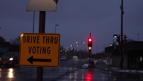 A-night-shot-of-a-street-sign-showing-where-drive-thru-voting-is-taking-place