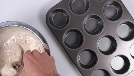 Filling-a-muffin-pan-with-a-spoon
