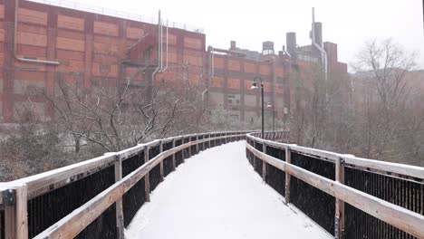 Snow-covered-wooden-bridge-during-fresh-snowfall