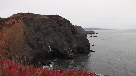 Hazy,-Cloudy,-Foggy-Cliffs-off-the-Coast-of-San-Francisco-Bay-with-Point-Bonita-Lighthouse-in-the-Distance
