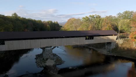 Old-Fashioned-Covered-Bridge-for-Traveling-in-New-England-Forest-Landscape---Aerial-establishing-Drone-view