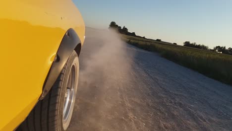 Yellow-Vintage-Car-Drives-on-a-Dusty-Rural-Gravel-Road-1