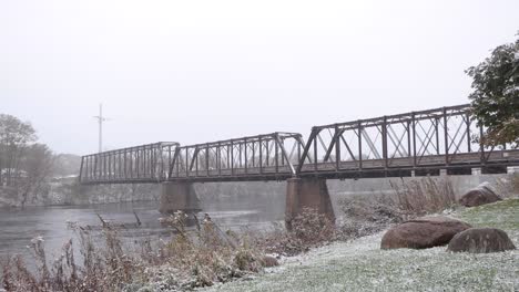 Bridge-over-Chippewa-River-during-the-snowfall-on-Chippewa-River-State-Trail,-in-Eau-Claire-Wisconsin,-Phoenix-Park