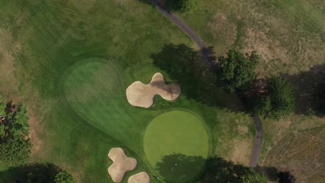 Aerial-birdseye-view-moving-above-golf-course-scenic-colourful-landscape