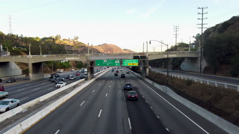 Los-Angeles-and-Hollywood-Freeway-Sign-Drone-shot-approaching-bridge