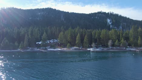 Drone-Truck-over-Lake-Tahoe-Fast-Northern-California-Winter-Snow-Capped-Mountains
