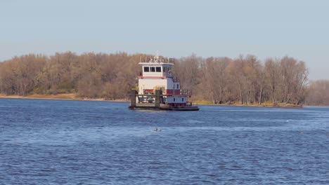 A-wide-angle-of-a-barge-with-no-cargo-is-moving-down-the-Mississippi-River