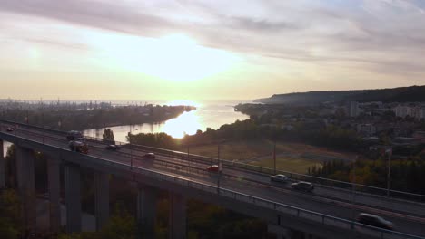Scenic-Sunrise-By-The-Asparuhov-Bridge-In-Varna,-Bulgaria-With-Reflection-On-Lake-Varna-Water---aerial