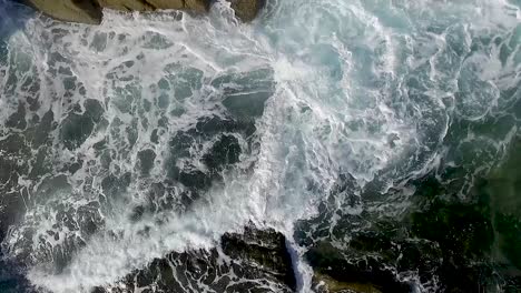 Slow-motion-Aerial-Waves-Breaking-On-Rocks-steady-close-up-slow