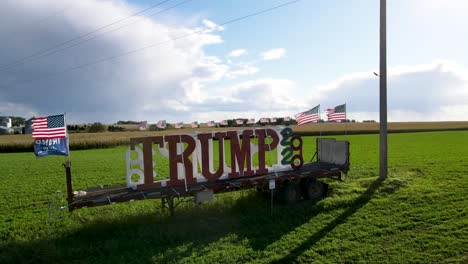 Trump-trailer-with-american-flags-sitting-in-the-grassy-field